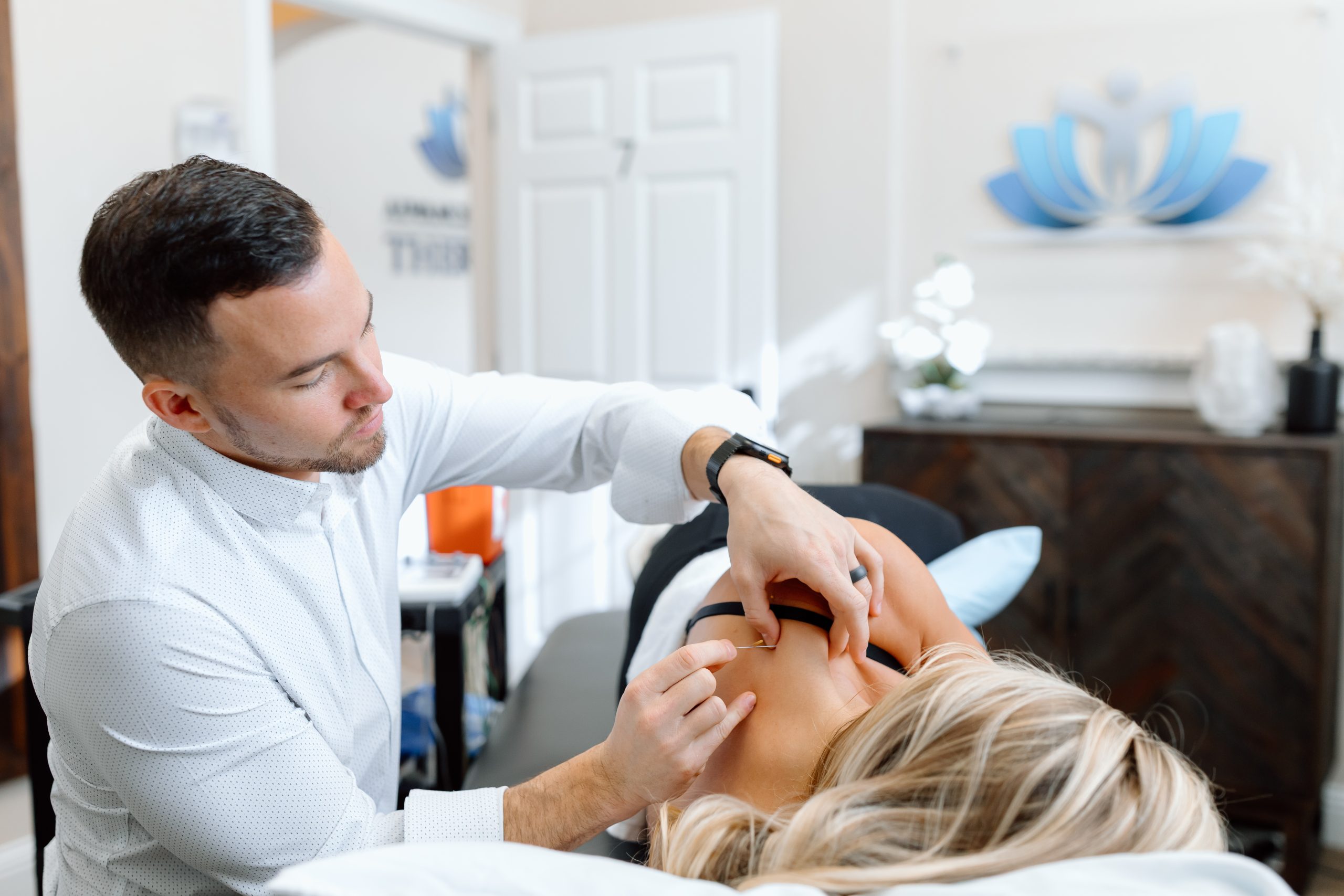 Dr. Grant Smith performing dry needling treatment on a patient